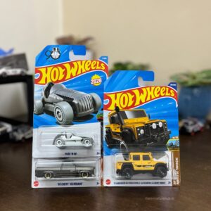 Hot Wheels 2026 A Case Pack of 3 featuring ’15 Land Rover Defender Double Cab (Yellow), ’83 Chevy Silverado, and Pass ’N Go. Latest 1:64 scale diecast set from The Miniature Hub.