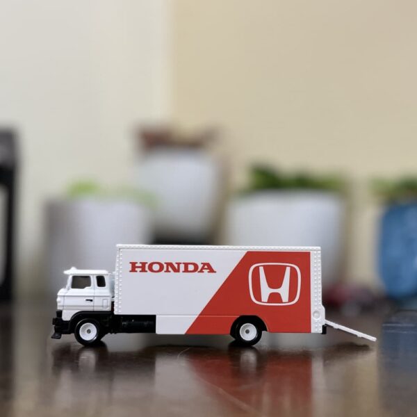 Hot Wheels Premium Honda Sakura Sprinter loose model with white and red Honda Racing livery on wooden surface