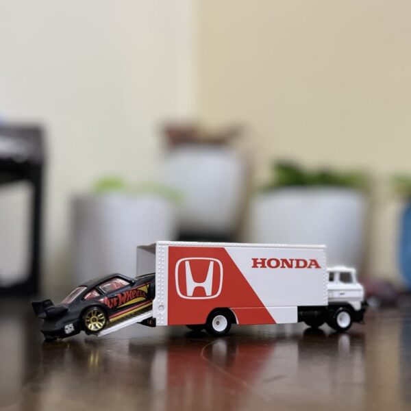 Hot Wheels Premium Honda Sakura Sprinter loose model with white and red Honda Racing livery on wooden surface