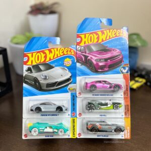 Hot Wheels Porsche vs Dodge Combo Pack of 5 featuring Porsche 911 Carrera T, Dodge Charger Hellcat, Slide Kick, Mod Mill, and Draft'N Break. Available at The Miniature Hub.